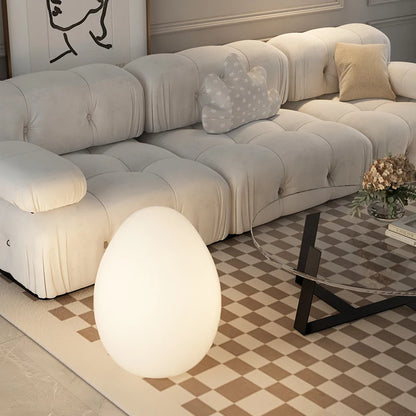 Lampe en forme d'oeuf posée sur le tapis de salon